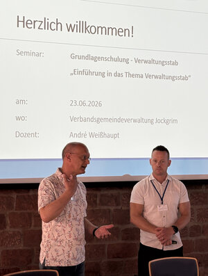 Bild vergr&ouml;&szlig;ern: Man sieht B&uuml;rgermeister Karl Dieter W&uuml;nstel und Dozent Andr&eacute; Wei&szlig;haupt vor der Pr&auml;sentation stehen.